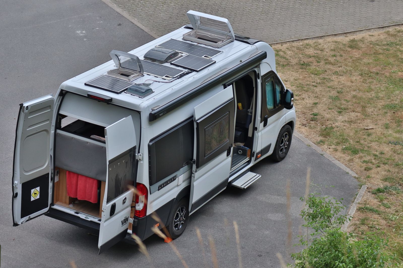 Campervan with rooftop solar panels parked outdoors