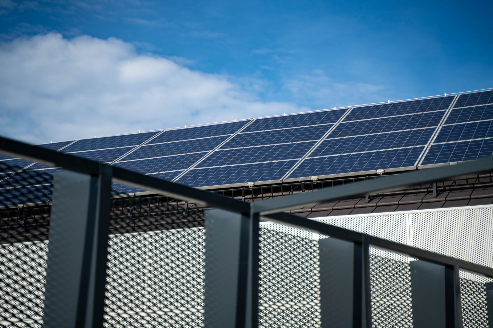 Solar panels installed on a roof under a blue sky